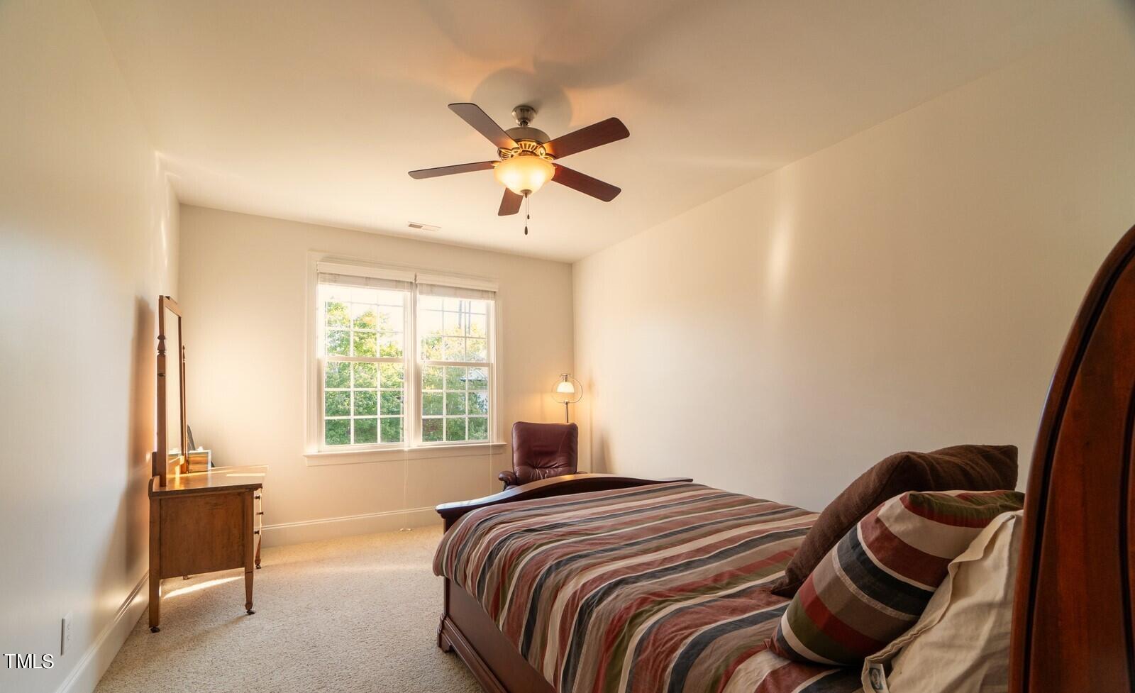 4211 Forest Edge Trail Durham, NC 27705 - Photo 33 of 62 a bedroom with a bed and a chandelier