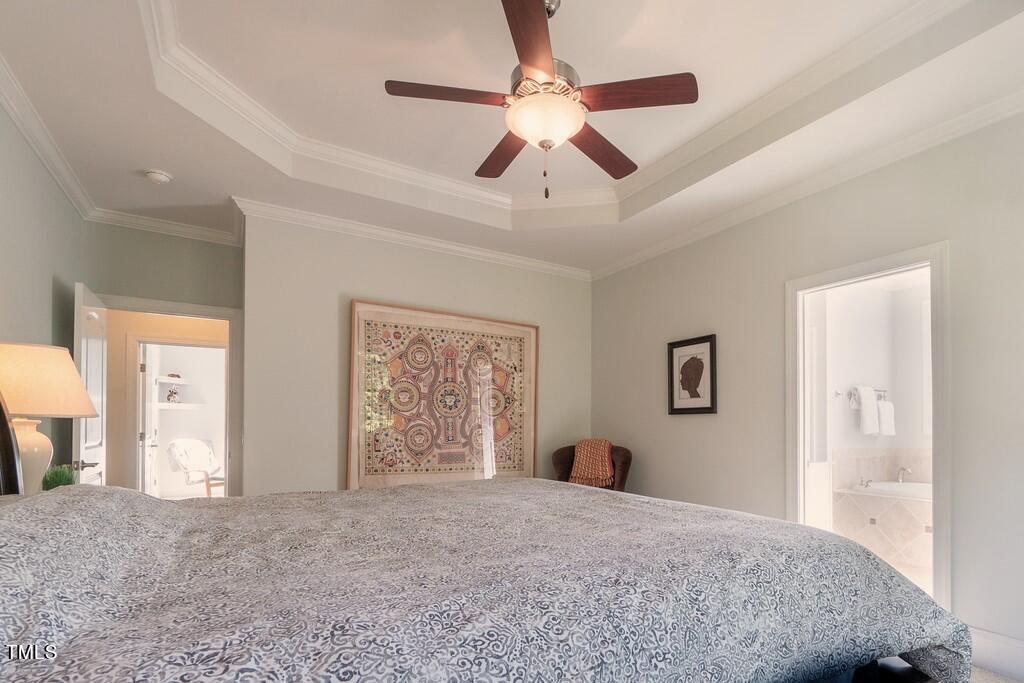 4211 Forest Edge Trail Durham, NC 27705 - Photo 44 of 62 a bedroom with a large bed and a chandelier