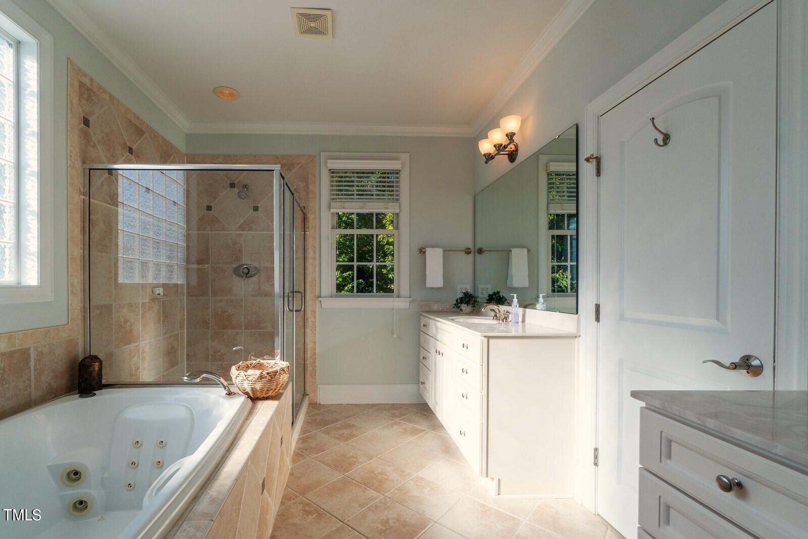 4211 Forest Edge Trail Durham, NC 27705 - Photo 46 of 62 a bathroom with a bathtub sink and mirror
