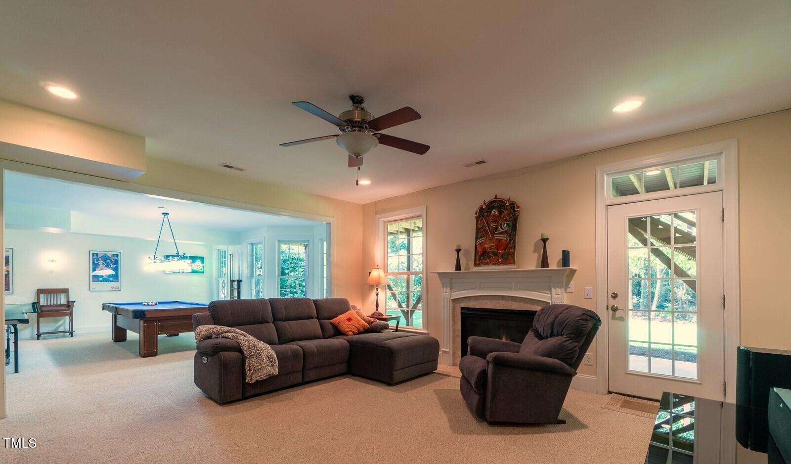 4211 Forest Edge Trail Durham, NC 27705 - Photo 52 of 62 a living room with furniture a fireplace and a large window