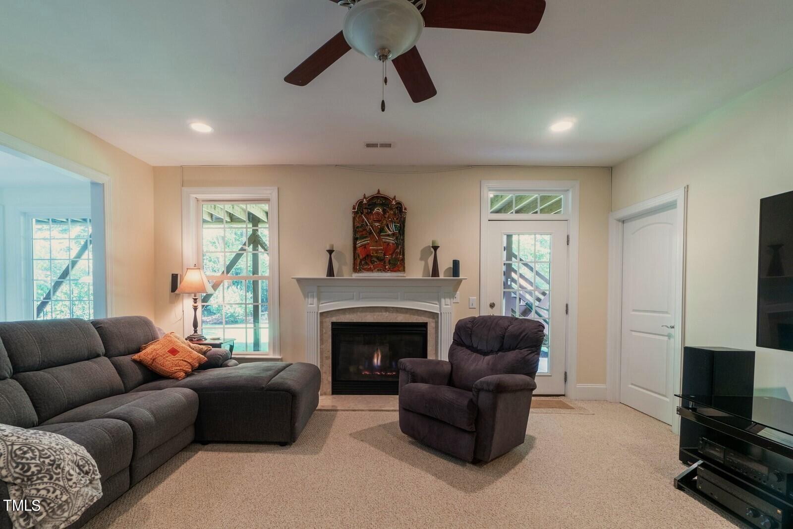 4211 Forest Edge Trail Durham, NC 27705 - Photo 54 of 62 a living room with furniture a window and a fireplace