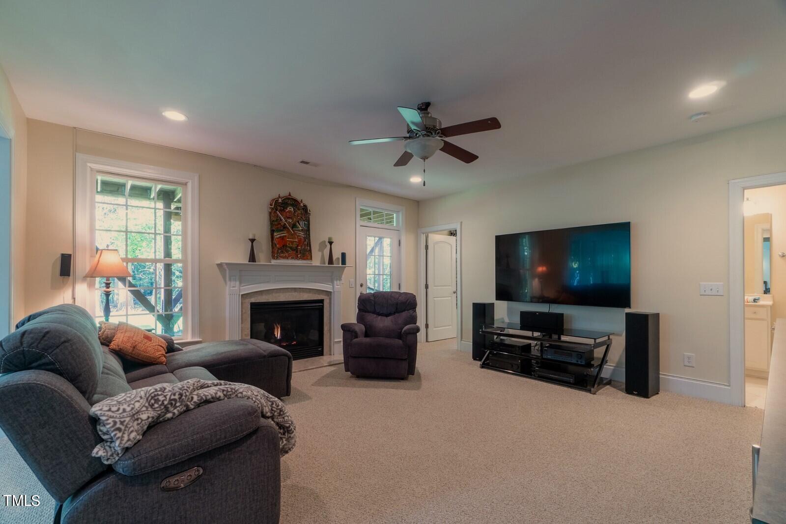 4211 Forest Edge Trail Durham, NC 27705 - Photo 55 of 62 a living room with furniture a fireplace and a flat screen tv