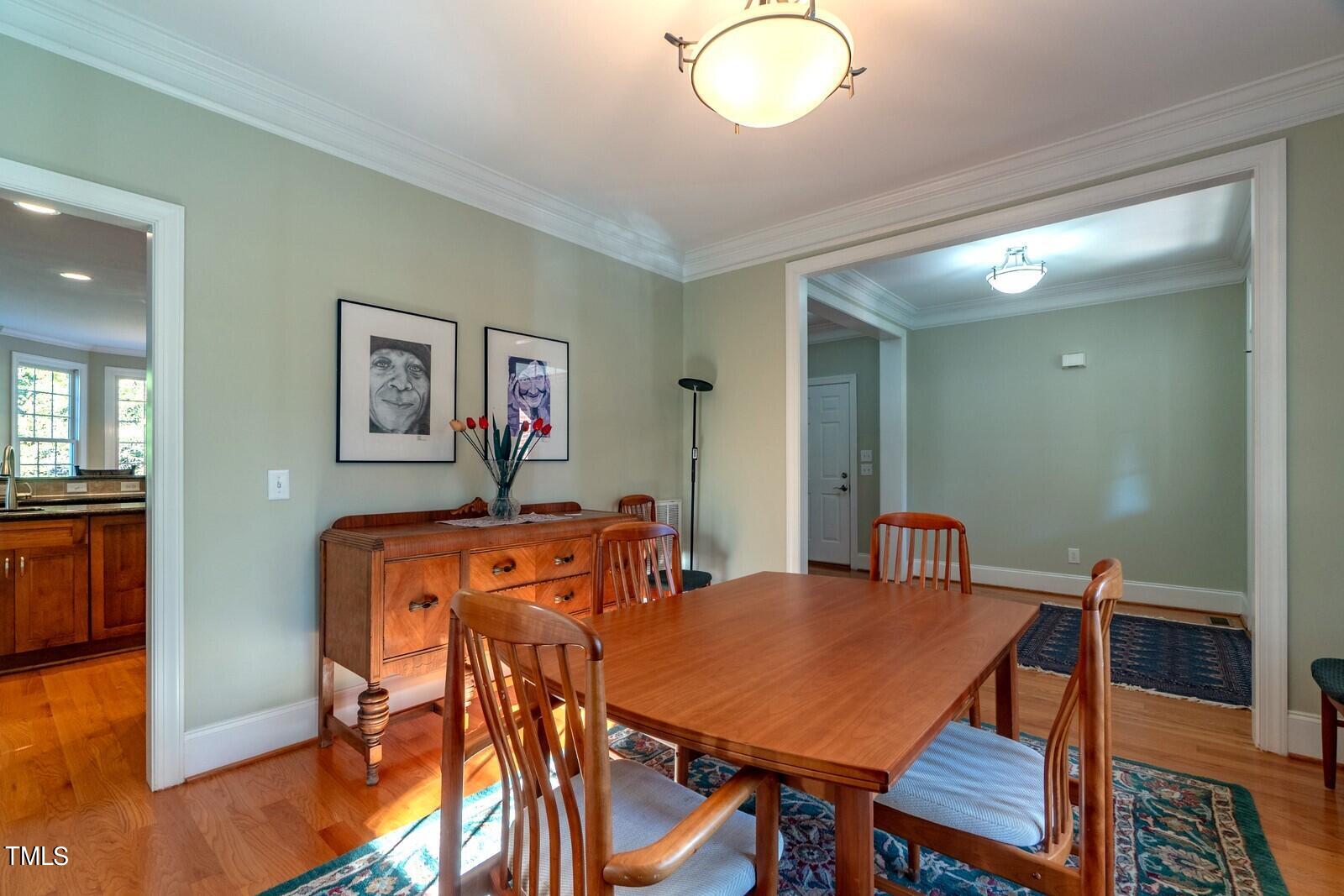 4211 Forest Edge Trail Durham, NC 27705 - Photo 7 of 62 a view of a dining room with furniture and wooden floor