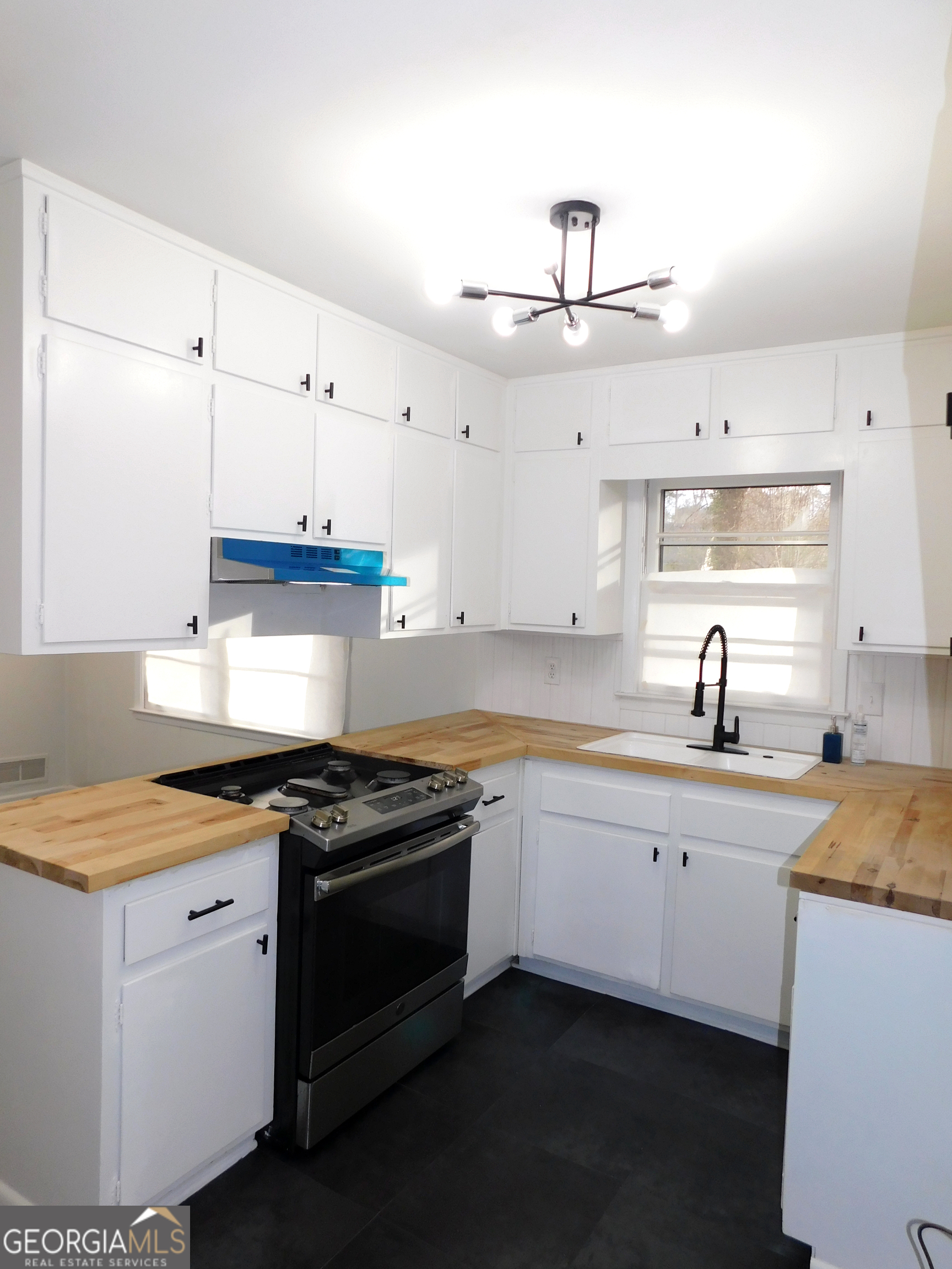4371 Aldergate Drive Decatur, GA 30035 - Photo 11 of 37 a kitchen with stainless steel appliances granite countertop a sink stove and cabinets