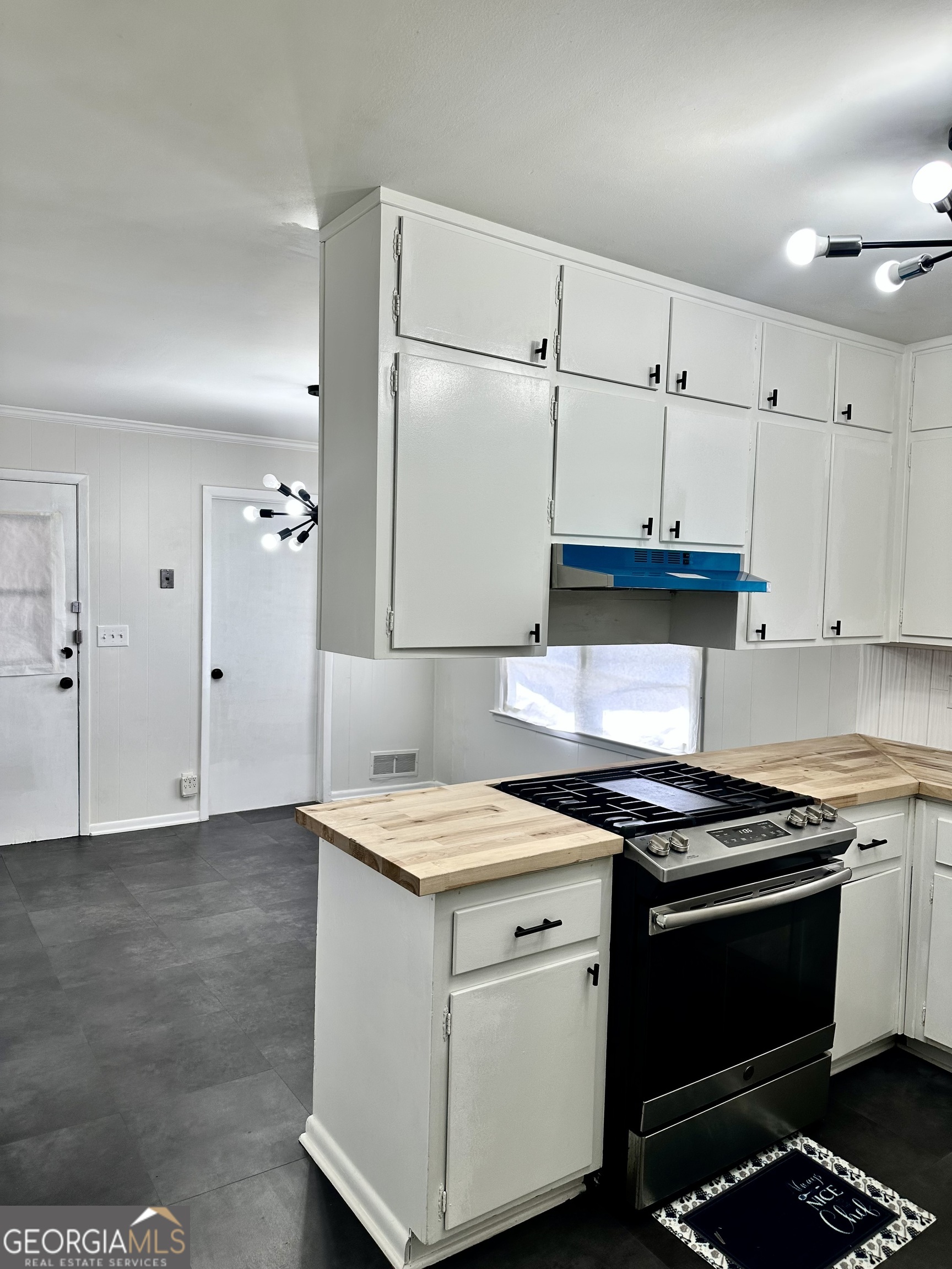 4371 Aldergate Drive Decatur, GA 30035 - Photo 13 of 37 a kitchen with a stove and white cabinets