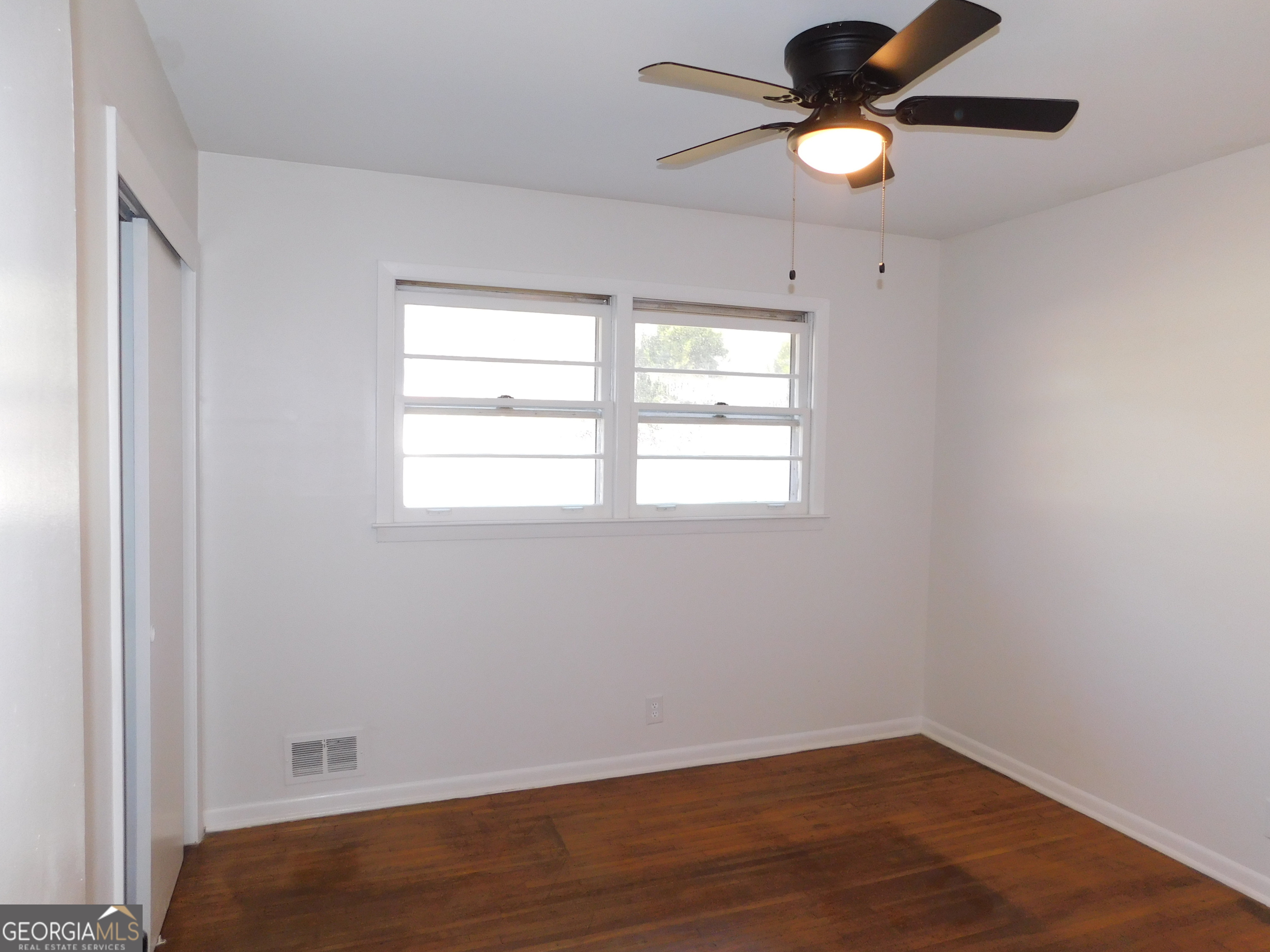 4371 Aldergate Drive Decatur, GA 30035 - Photo 31 of 37 a view of an empty room with window and wooden floor