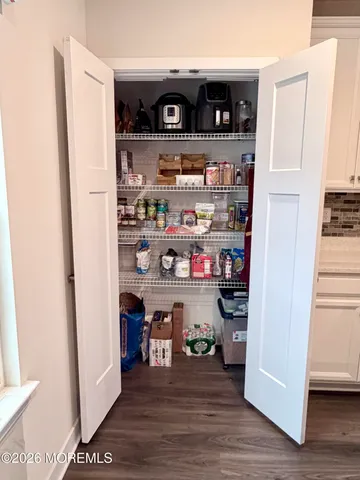 a view of staircase with white walls and a window