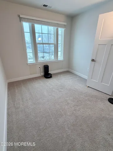 a bedroom with a large bed and a flat screen tv