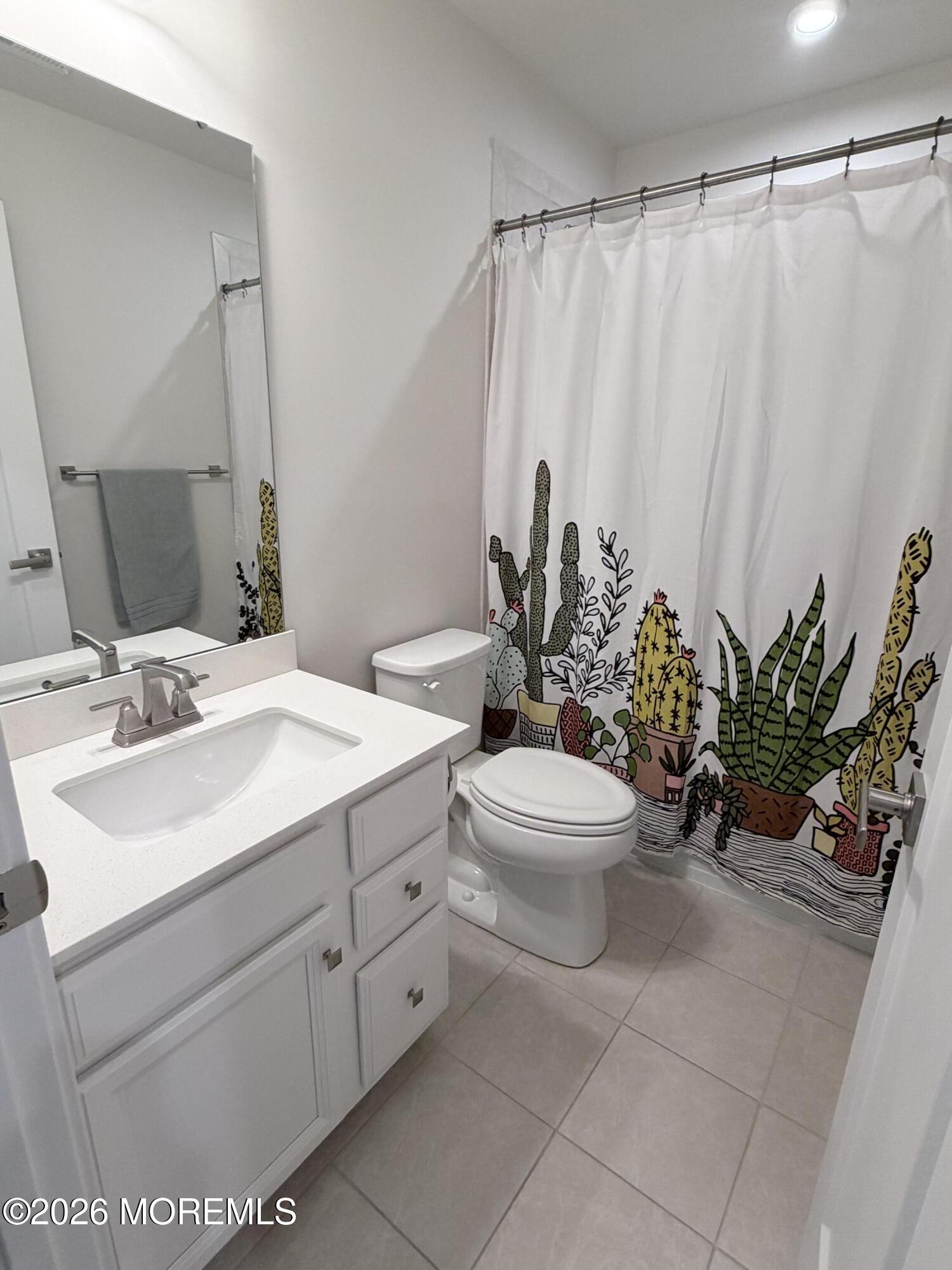 1207 English Lane, Unit 1207 Parlin, NJ 08859 - Photo 32 of 56 a bathroom with a sink a mirror and a toilet