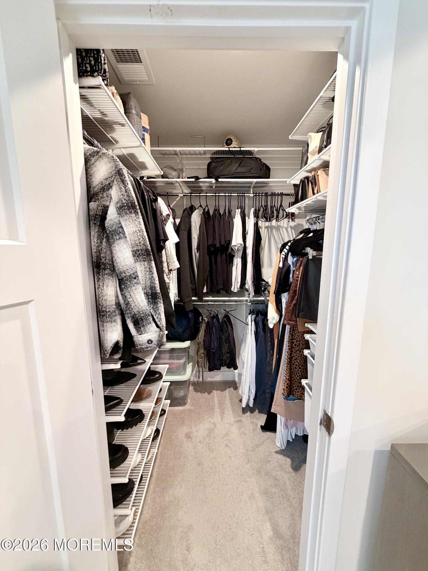1207 English Lane, Unit 1207 Parlin, NJ 08859 - Photo 39 of 56 a view of walk in closet with clothes and shoes