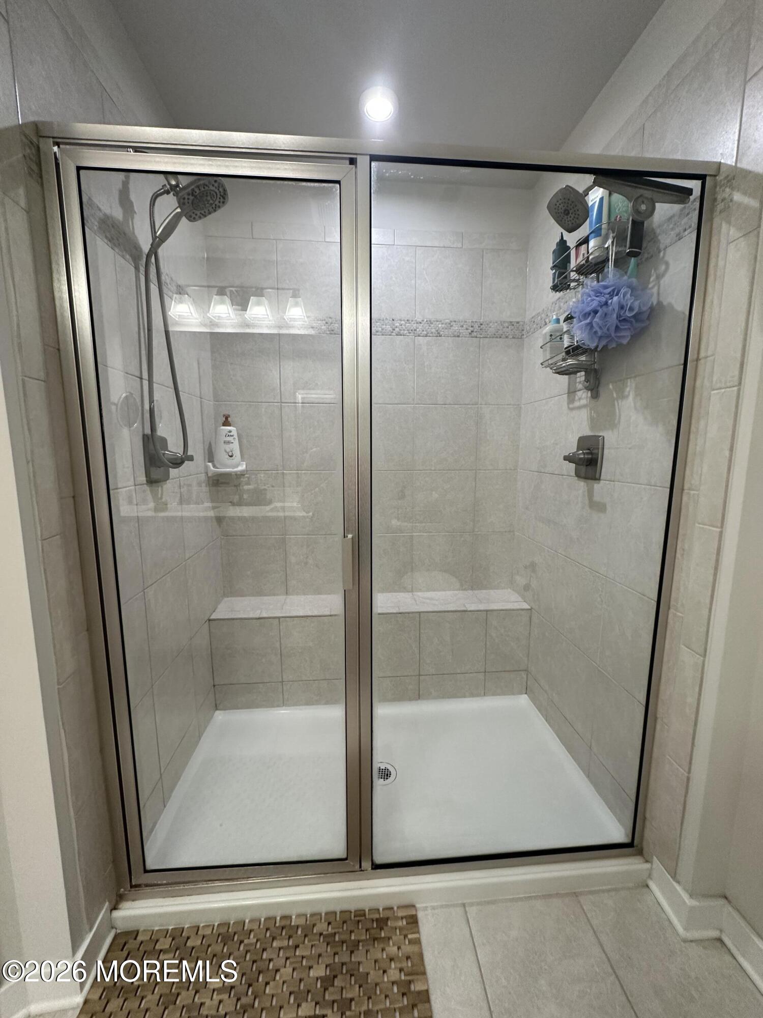 1207 English Lane, Unit 1207 Parlin, NJ 08859 - Photo 42 of 56 a bathroom with a glass shower door