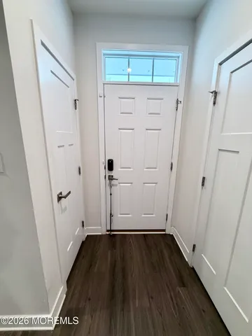 a living room with furniture a flat screen tv and a wall painting