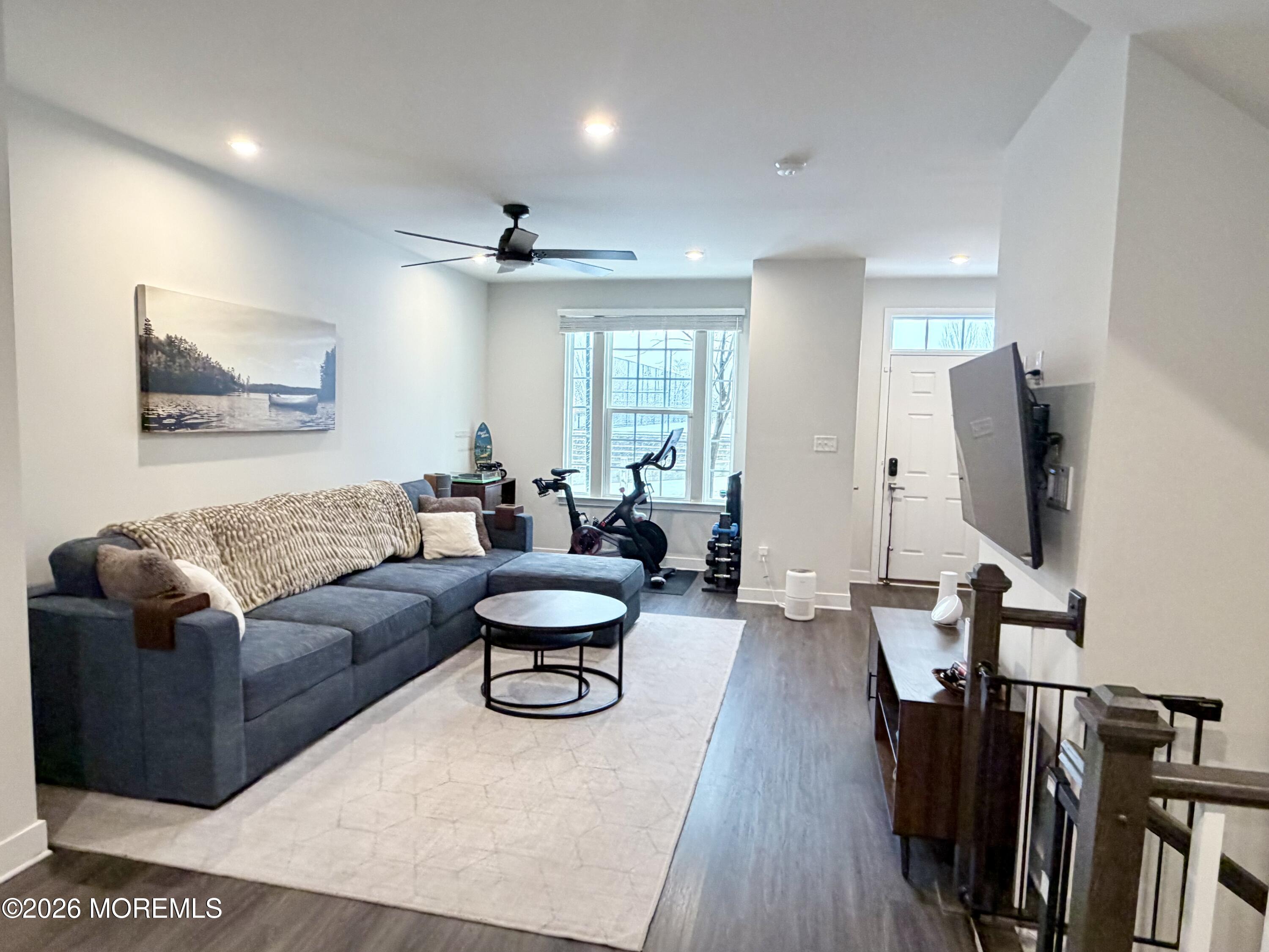 1207 English Lane, Unit 1207 Parlin, NJ 08859 - Photo 9 of 56 a living room with furniture a flat screen tv and a wall painting