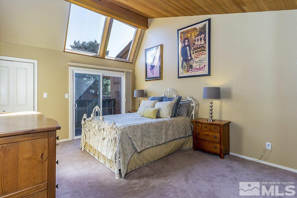 1860 Villa Way Reno, NV 89509 - Photo 13 of 21 a bedroom with a bed and a chandelier