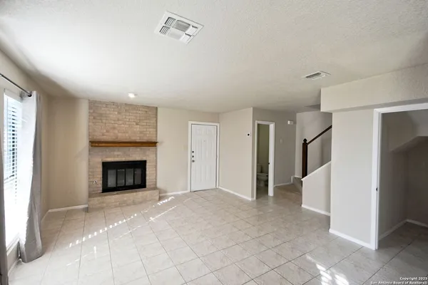 a view of an empty room with a fireplace
