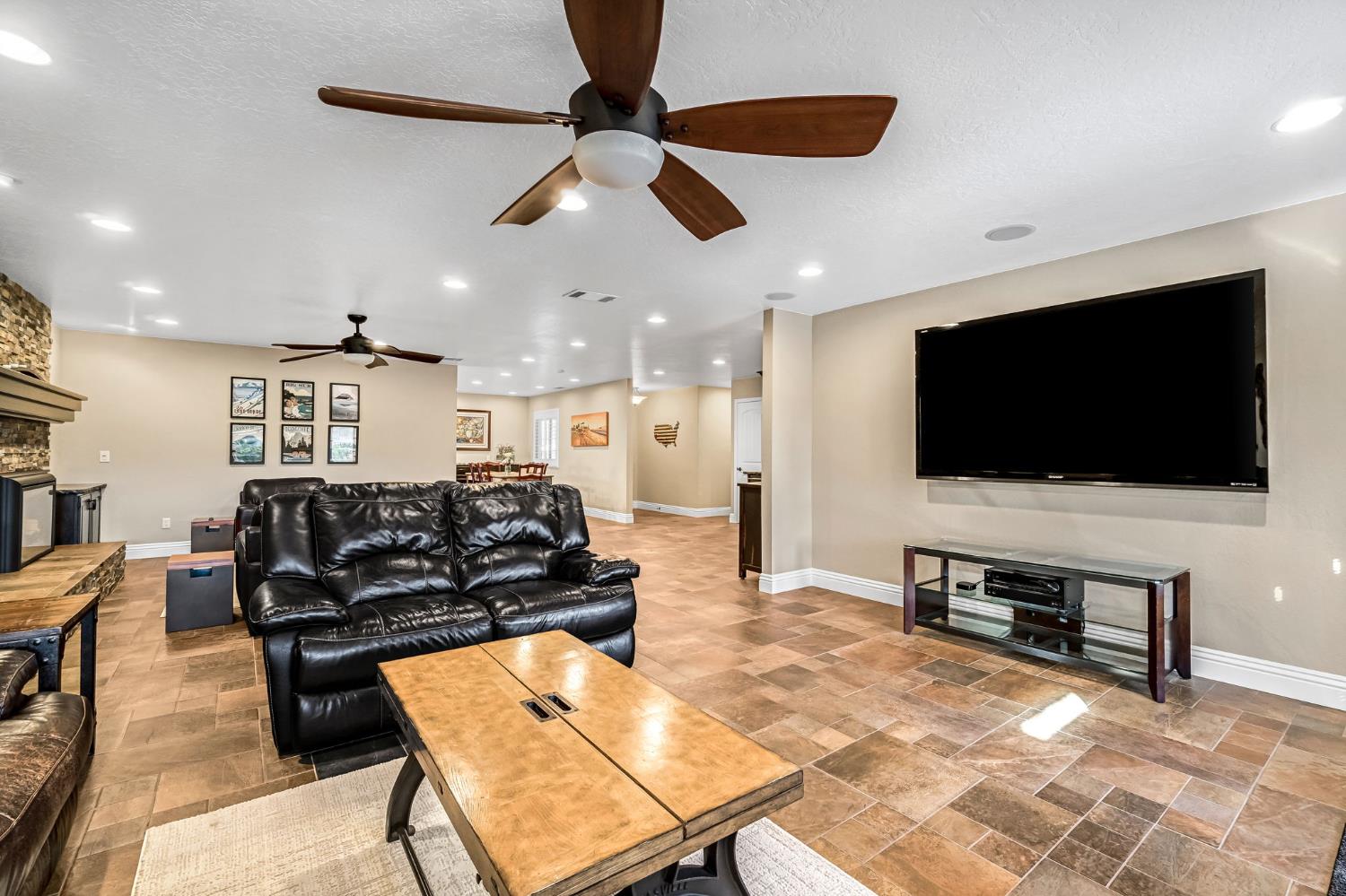 505 Ash Street Lemoore, CA 93245 - Photo 11 of 66 a living room with furniture and a flat screen tv
