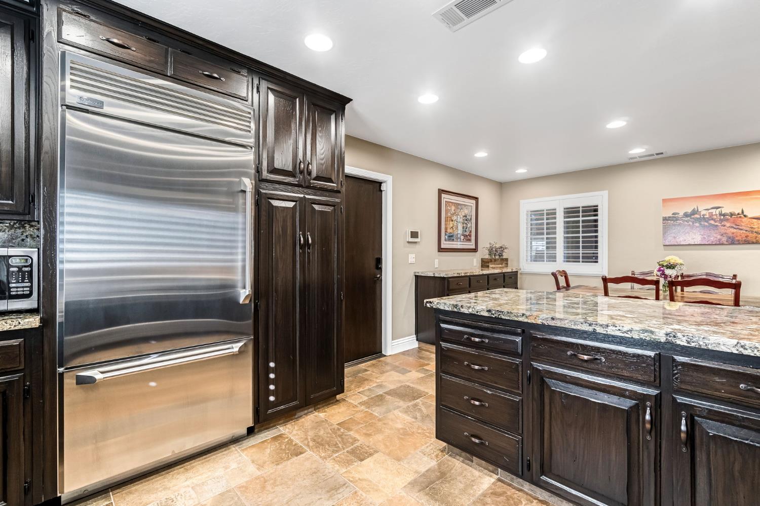 505 Ash Street Lemoore, CA 93245 - Photo 19 of 66 a kitchen with granite countertop stainless steel appliances and counter space
