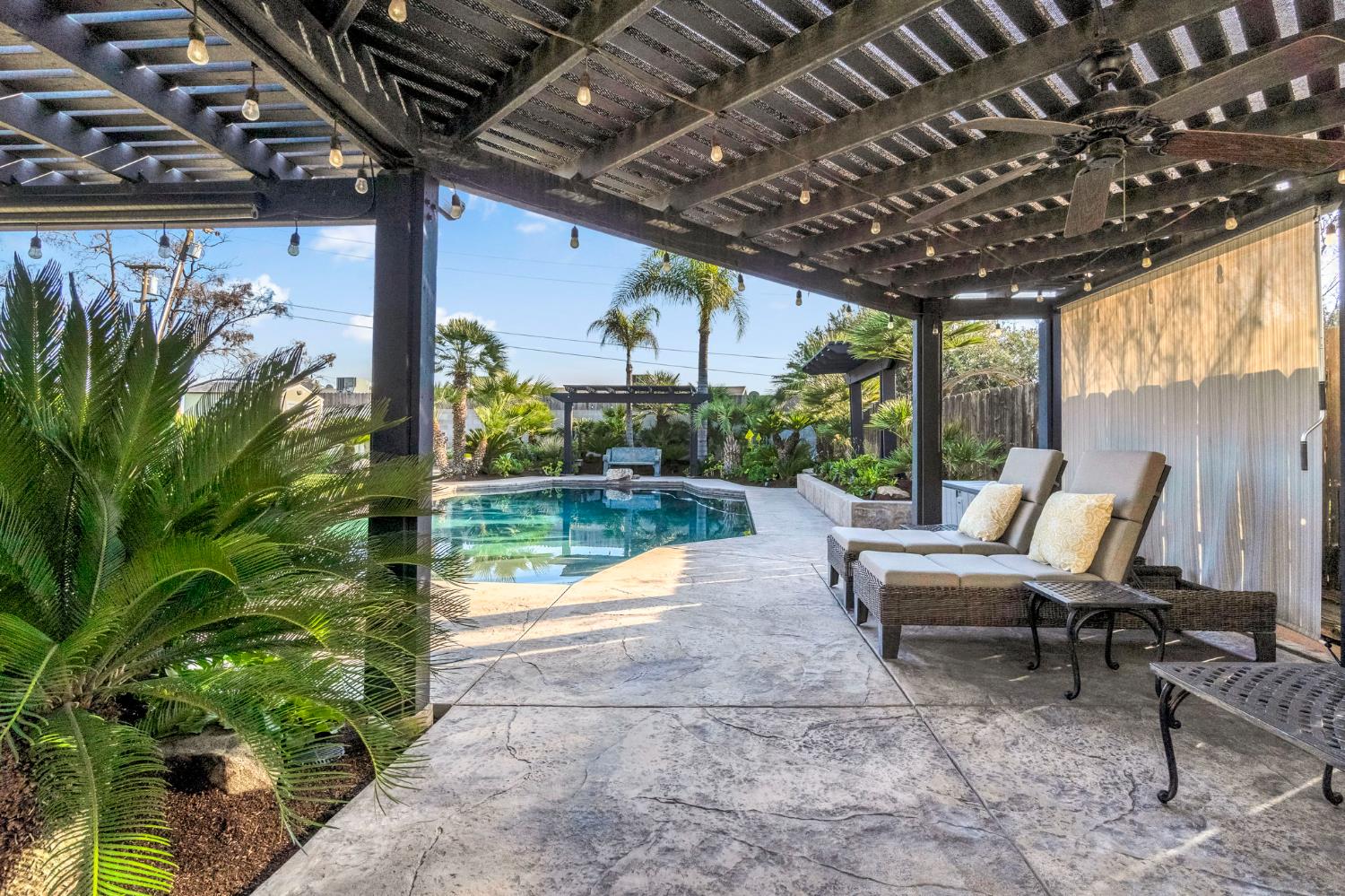 505 Ash Street Lemoore, CA 93245 - Photo 32 of 66 a view of a patio with table and chairs potted plants with floor to ceiling window and garden