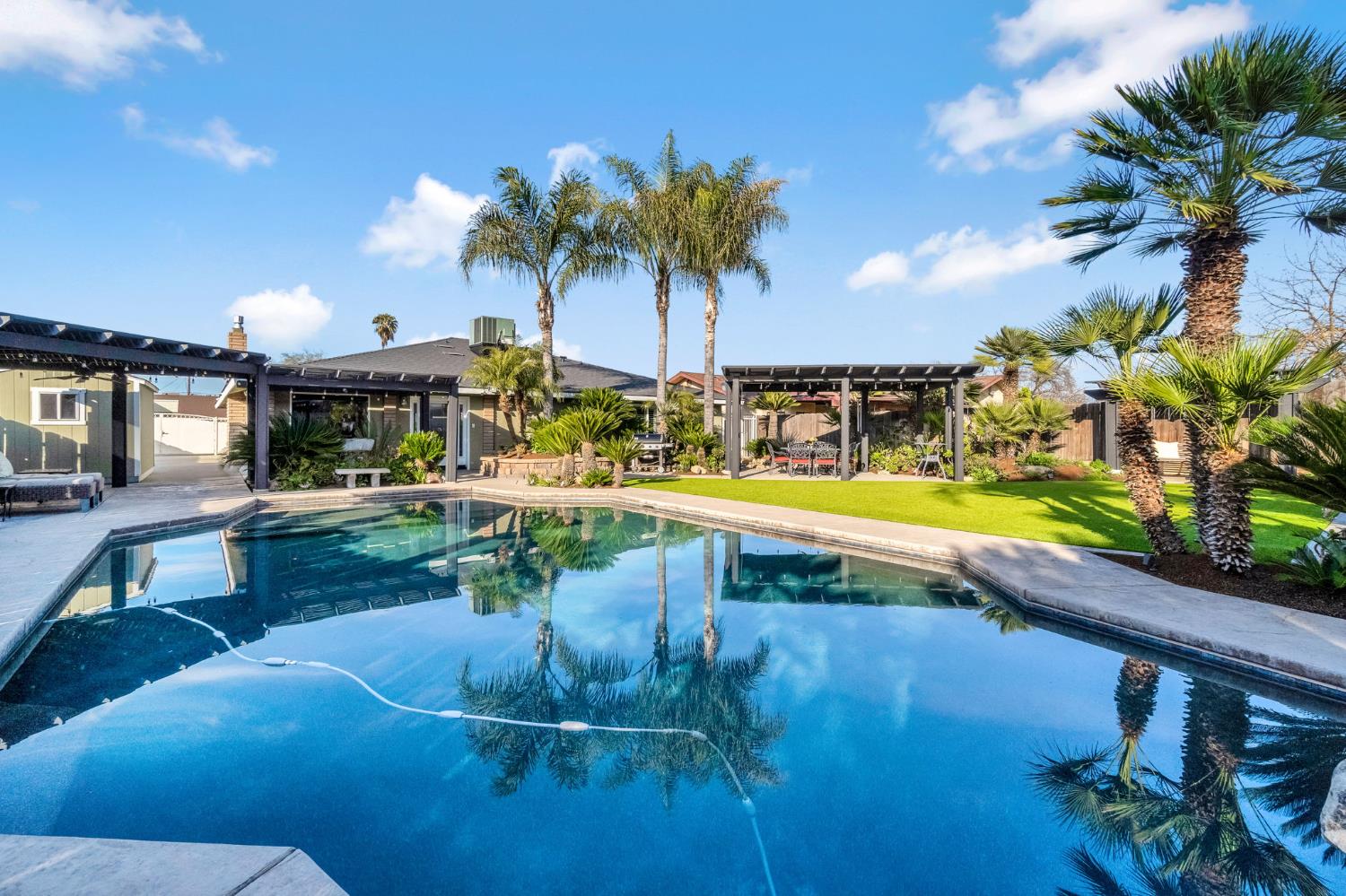 505 Ash Street Lemoore, CA 93245 - Photo 36 of 66 a view of a swimming pool with a table and chairs