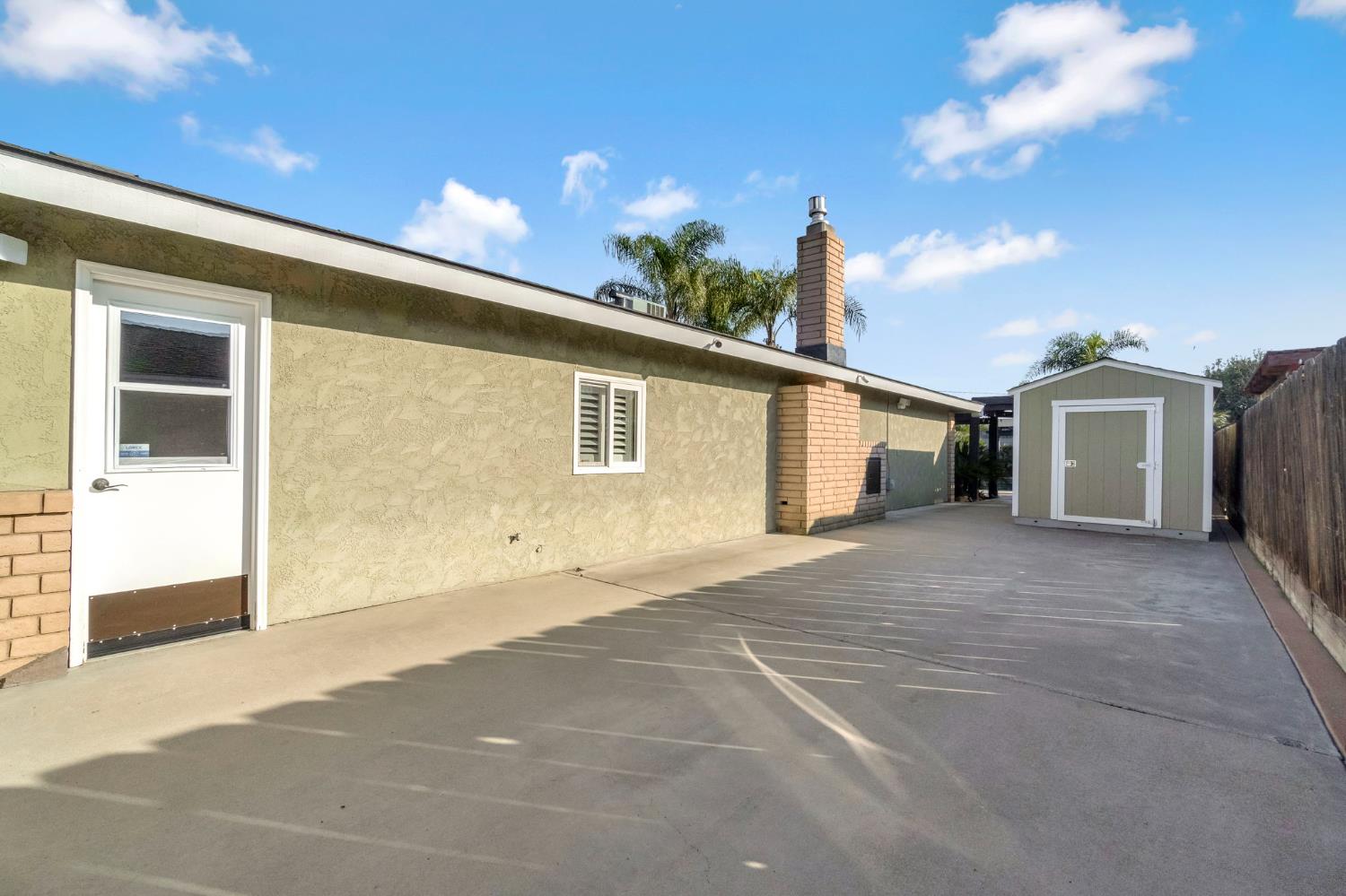 505 Ash Street Lemoore, CA 93245 - Photo 42 of 66 a front view of a house with a yard and garage