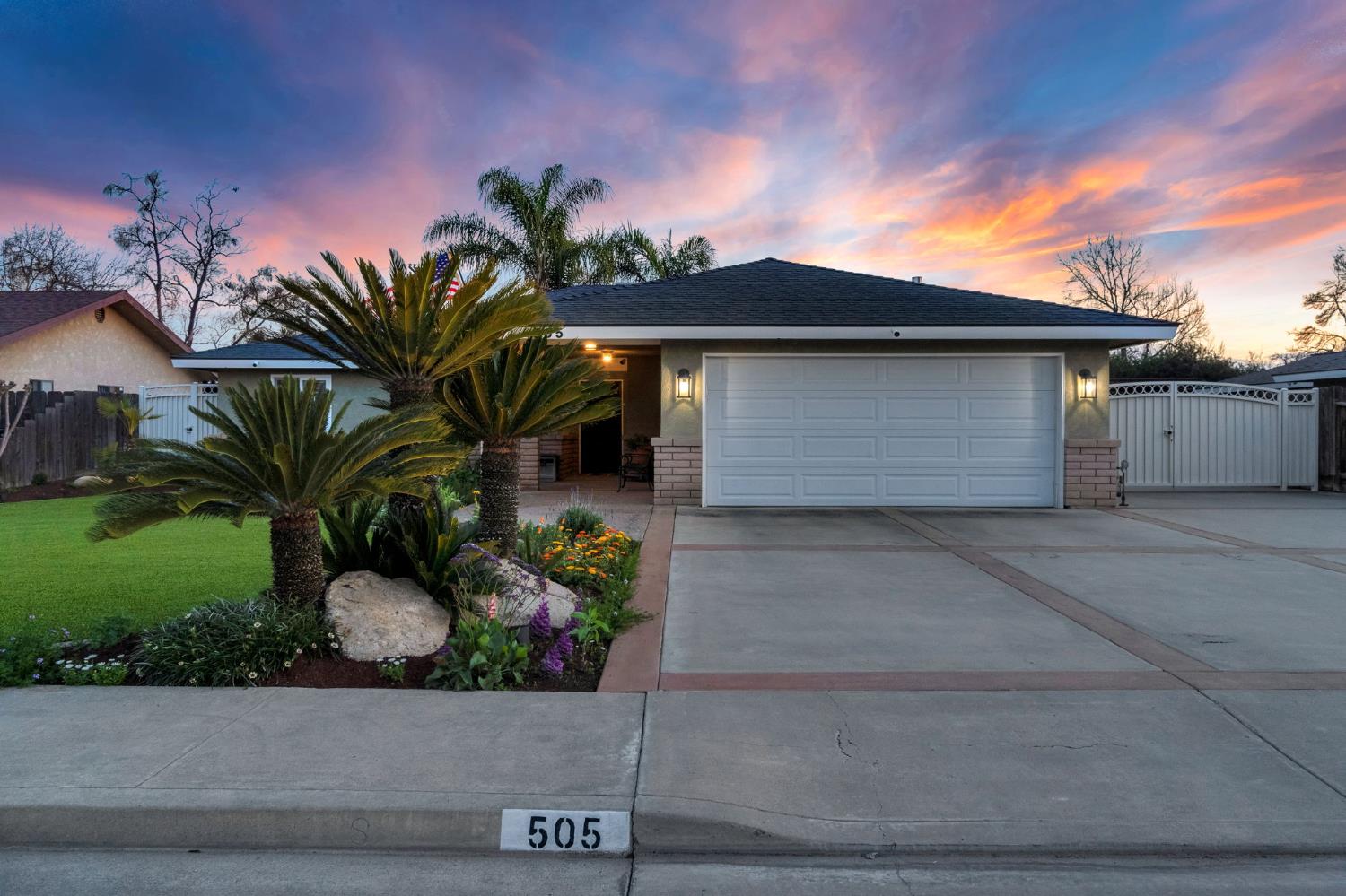 505 Ash Street Lemoore, CA 93245 - Photo 56 of 66 a front view of a house with a garage