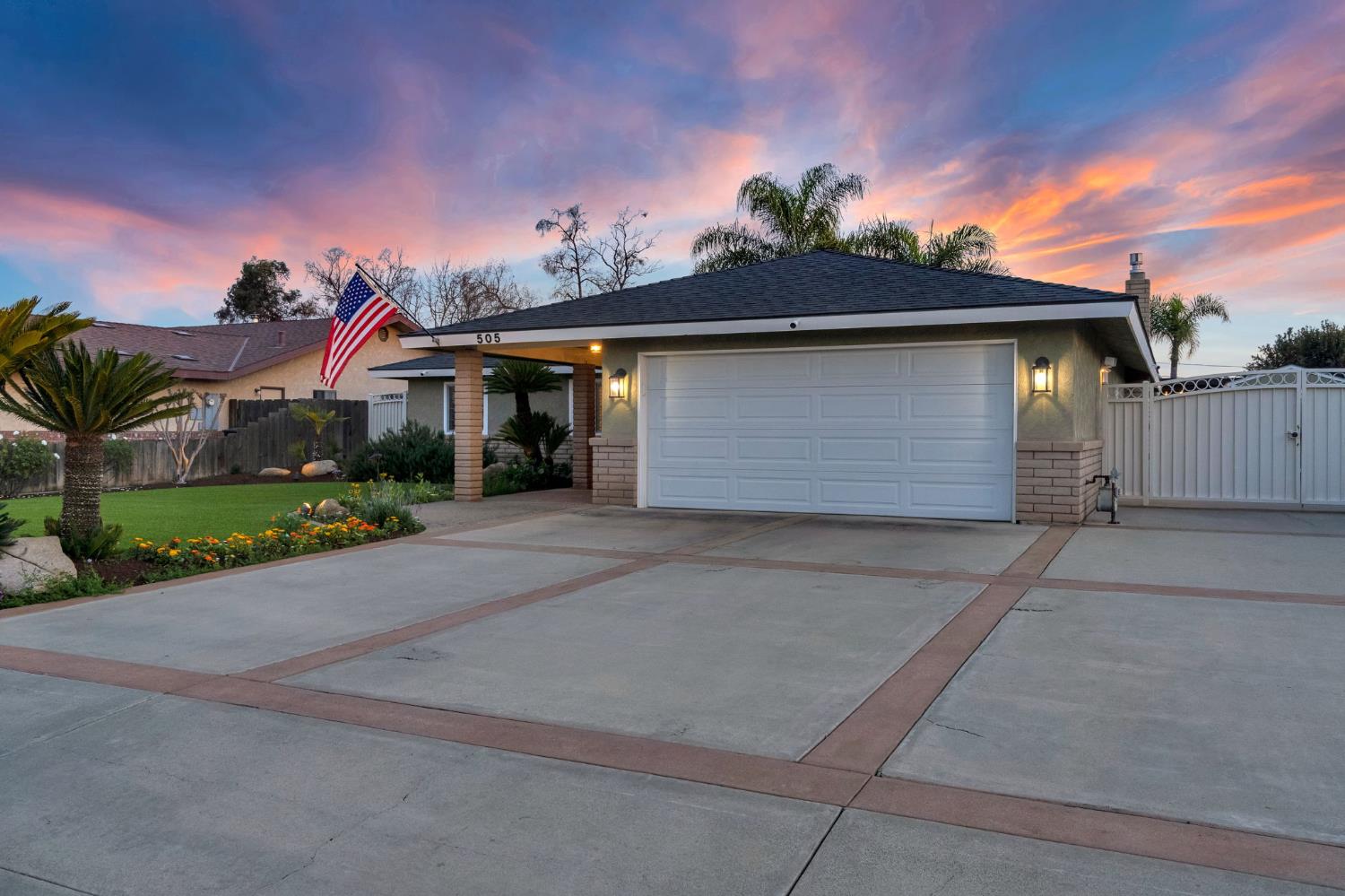 505 Ash Street Lemoore, CA 93245 - Photo 57 of 66 a front view of a house with a yard and garage