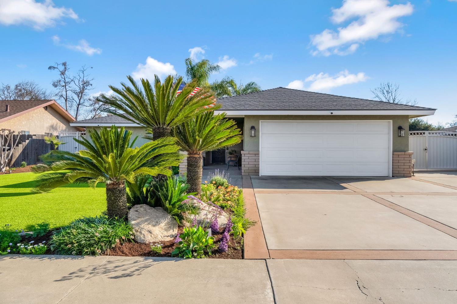 505 Ash Street Lemoore, CA 93245 - Photo 59 of 66 a front view of a house with a yard and garage