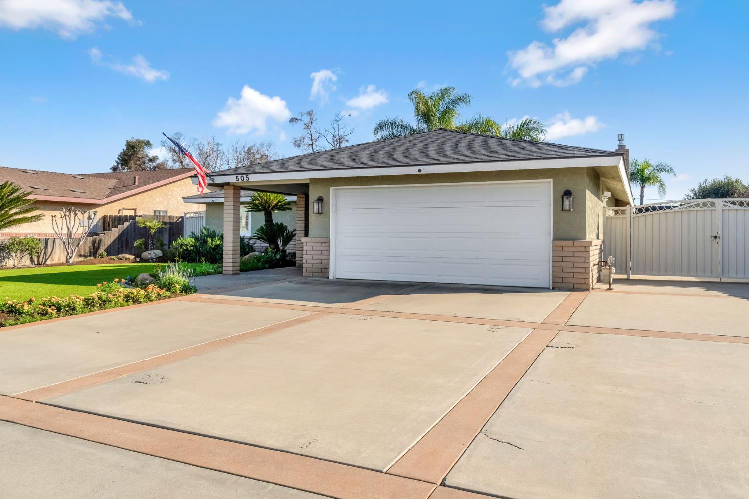 505 Ash Street Lemoore, CA 93245 - Photo 60 of 66 a front view of a house with a yard and garage