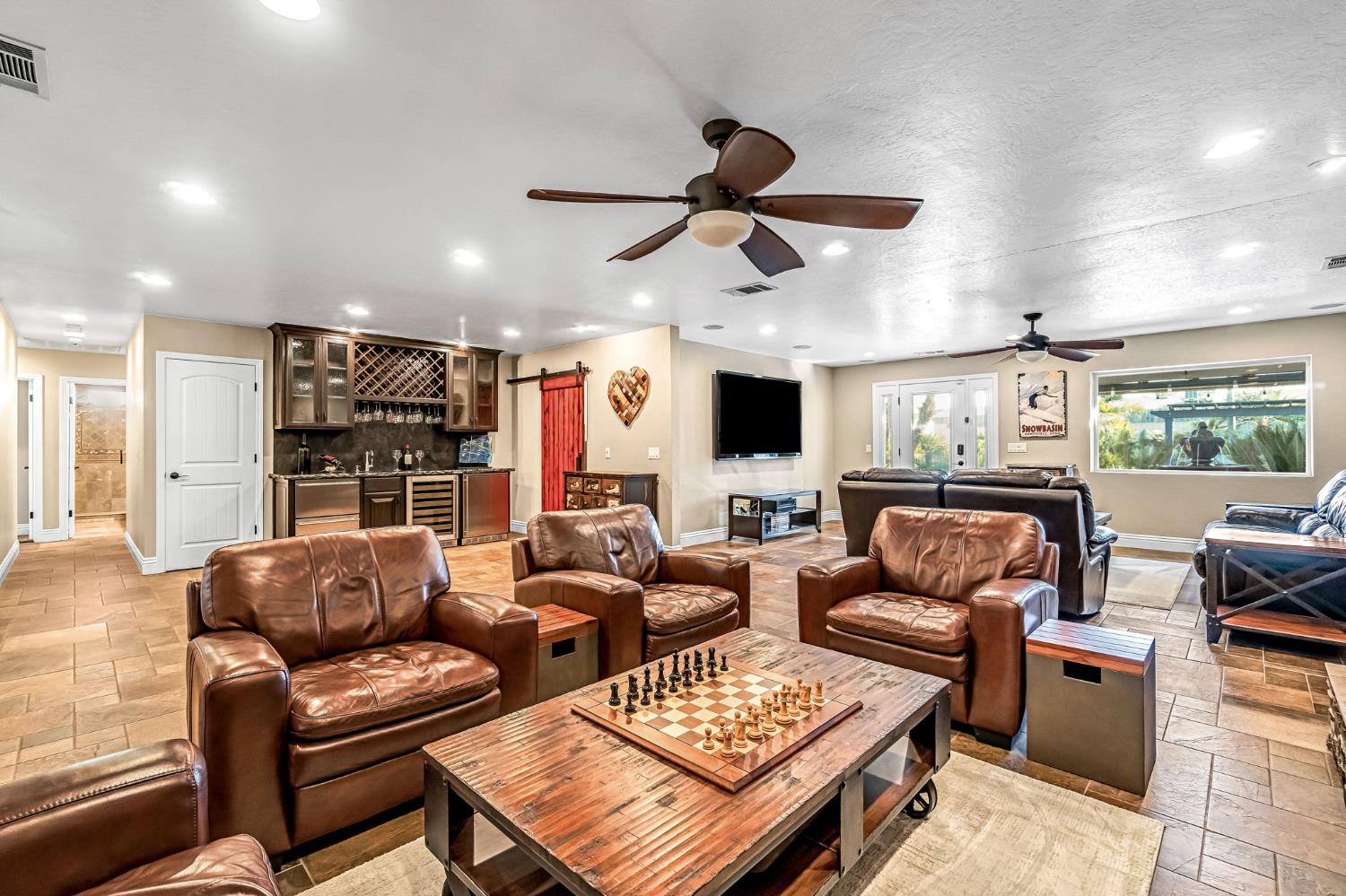 505 Ash Street Lemoore, CA 93245 - Photo 8 of 66 a living room with furniture ceiling fan and a window