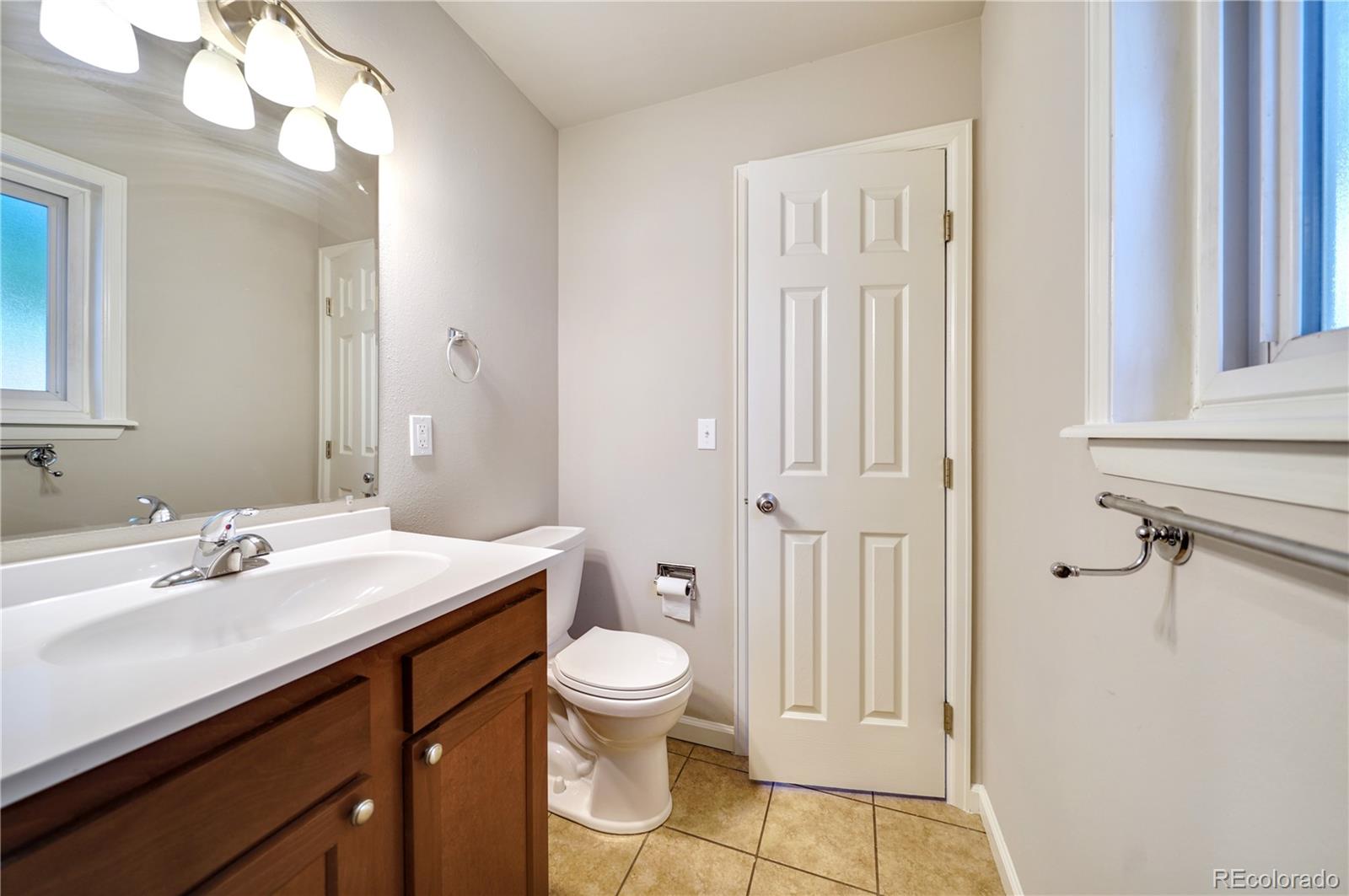 1206 Westmoreland Road Colorado Springs, CO 80907 - Photo 11 of 33 a bathroom with a sink a toilet and shower