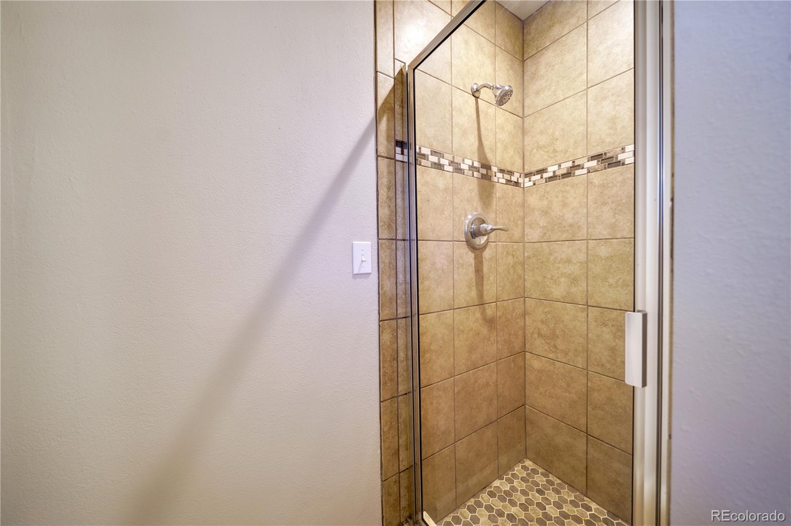 1206 Westmoreland Road Colorado Springs, CO 80907 - Photo 13 of 33 a bathroom with a shower