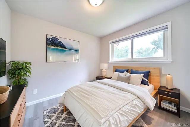 a bedroom with a bed and a potted plant