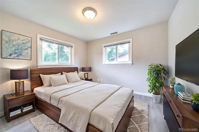 a bedroom with a bed and a flat screen tv