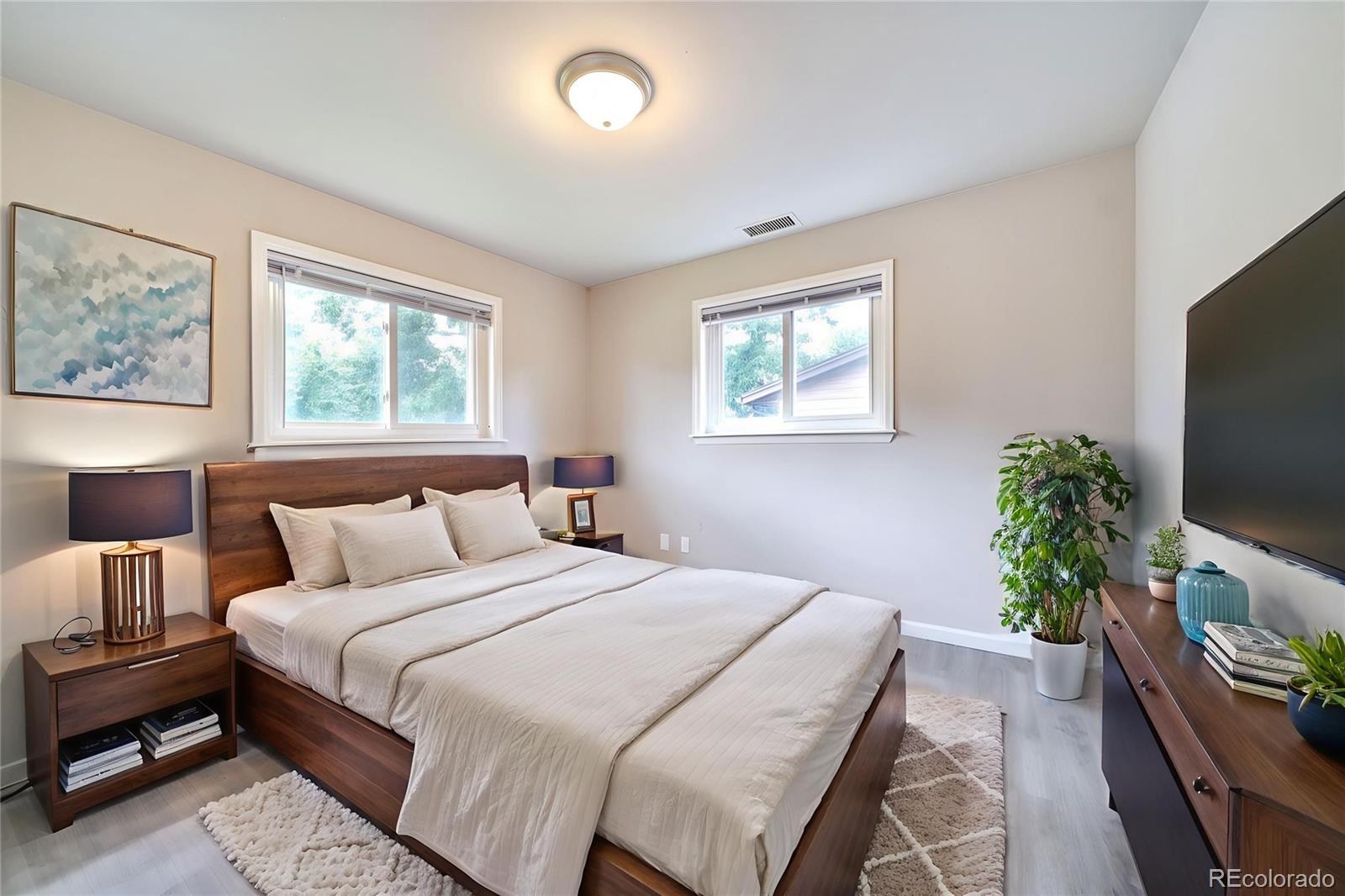 1206 Westmoreland Road Colorado Springs, CO 80907 - Photo 15 of 33 a bedroom with a bed and a flat screen tv