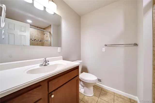a bathroom with a sink mirror vanity and toilet