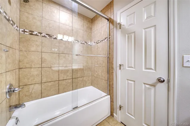 a bathroom with a tub and shower