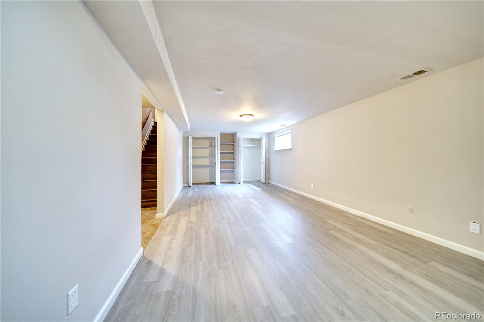 1206 Westmoreland Road Colorado Springs, CO 80907 - Photo 18 of 33 wooden floor in an empty room with a window