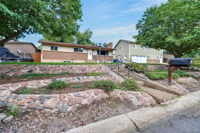 a front view of a house with a yard and a garage