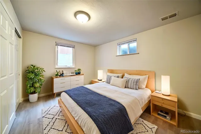 a bedroom with a bed and a potted plant