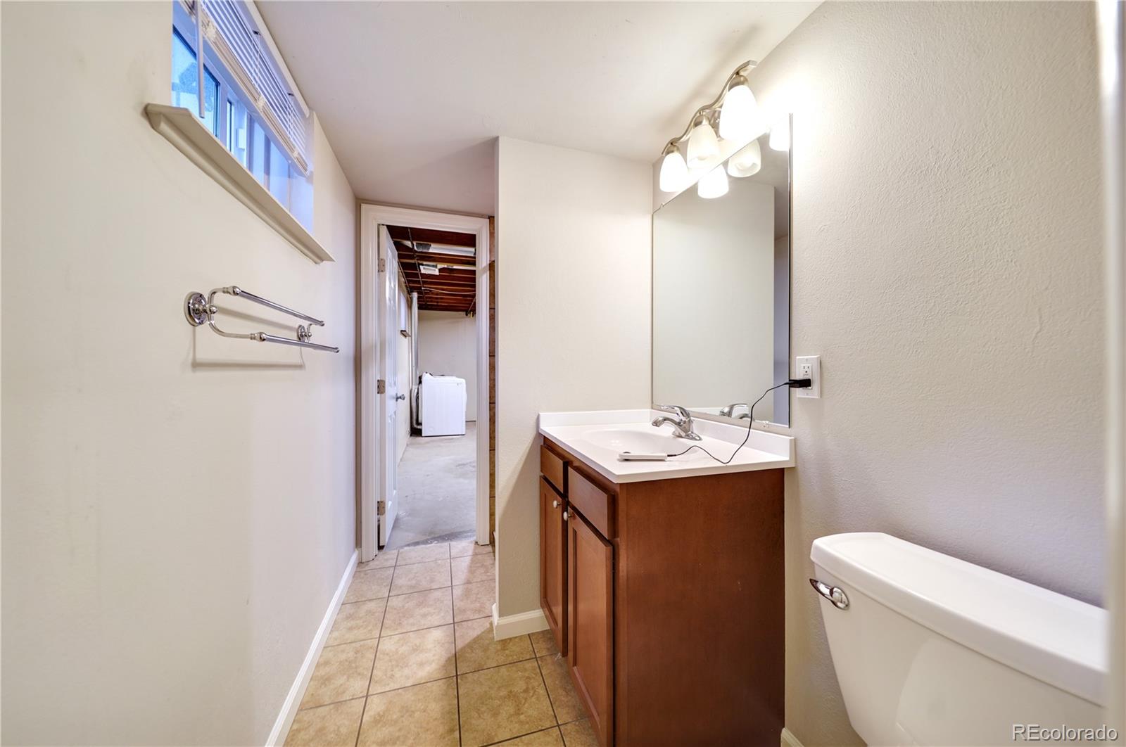 1206 Westmoreland Road Colorado Springs, CO 80907 - Photo 25 of 33 a bathroom with a sink a toilet and shower