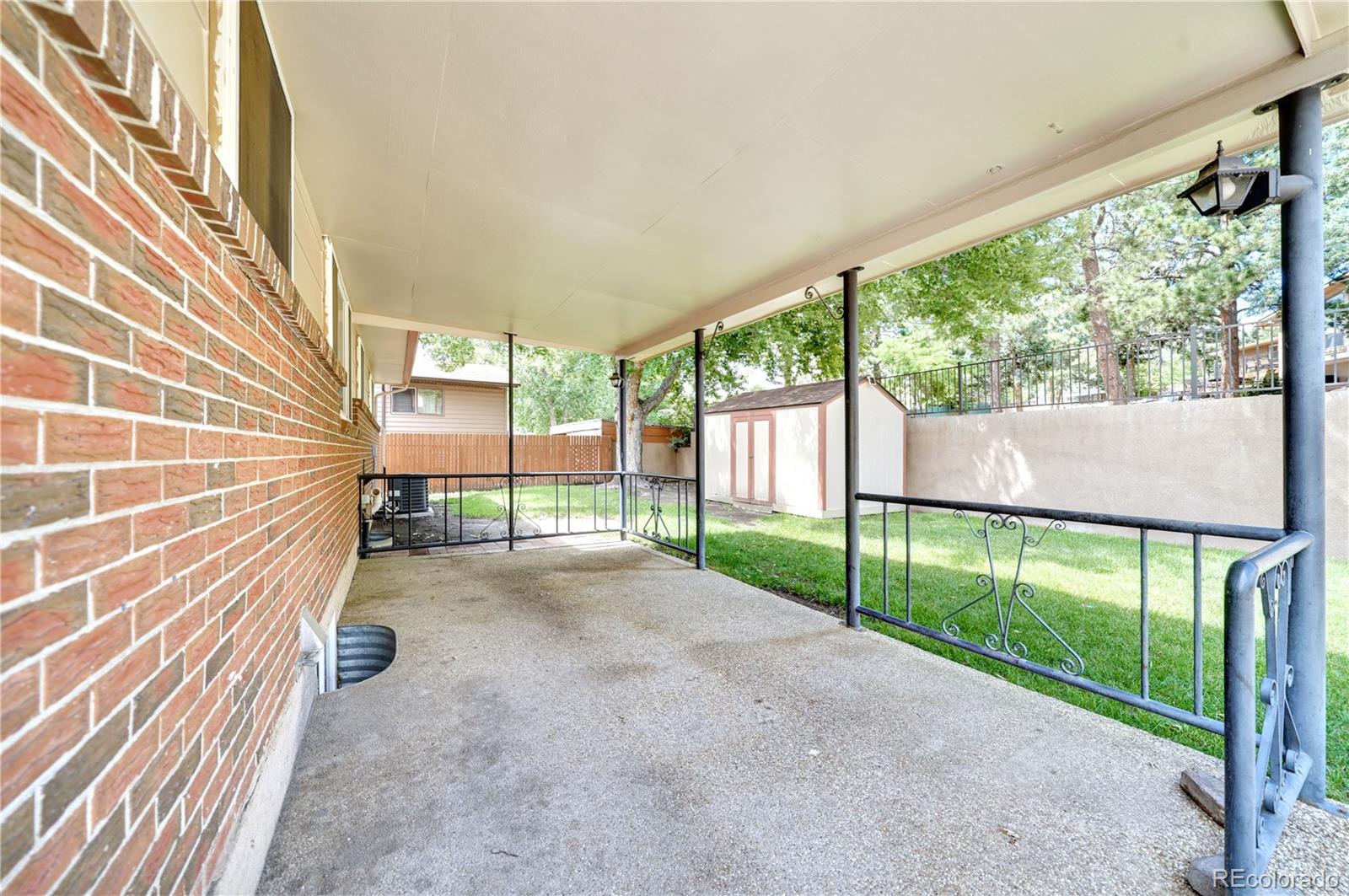 1206 Westmoreland Road Colorado Springs, CO 80907 - Photo 28 of 33 a view of porch with a floor to ceiling window and wooden fence