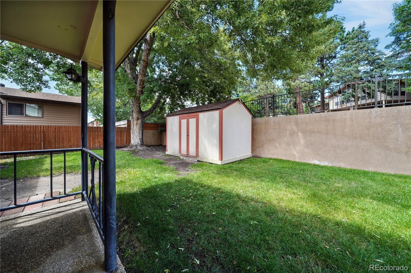 1206 Westmoreland Road Colorado Springs, CO 80907 - Photo 30 of 33 a view of a backyard with a garden and plants