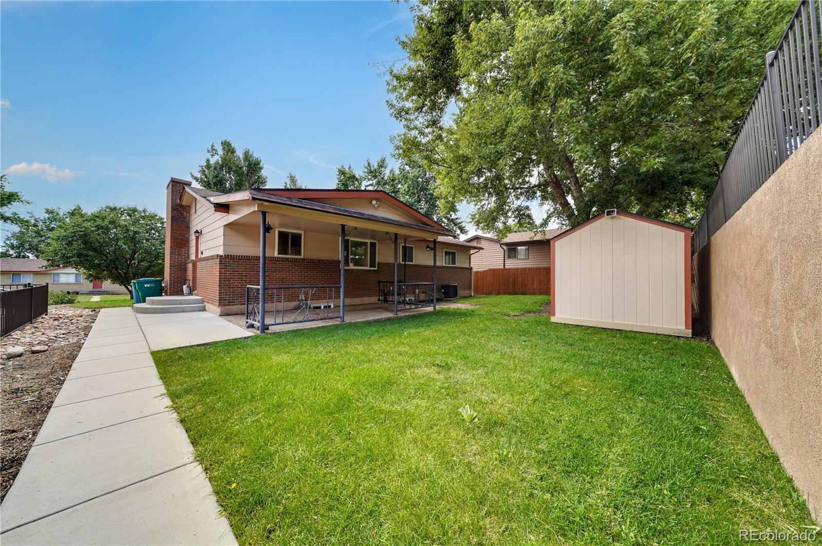1206 Westmoreland Road Colorado Springs, CO 80907 - Photo 31 of 33 a view of a house with a backyard