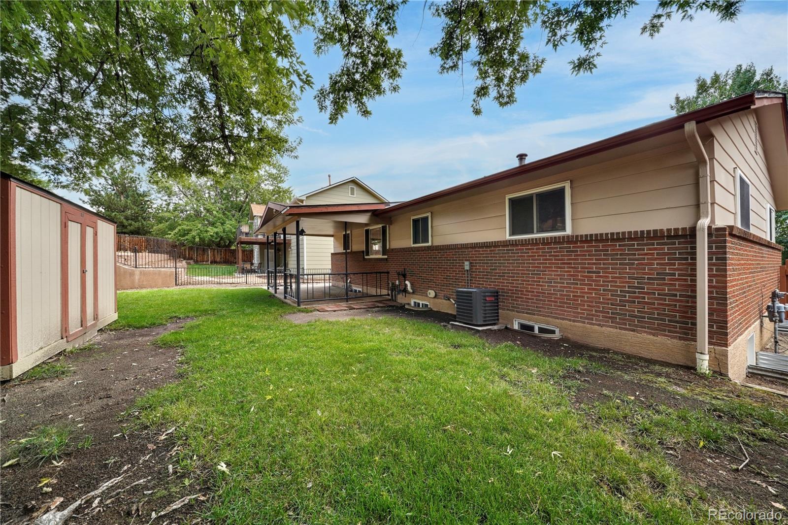 1206 Westmoreland Road Colorado Springs, CO 80907 - Photo 32 of 33 a front view of house with yard and trees in the background