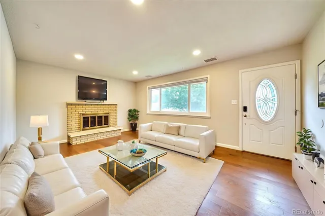 a living room with furniture fireplace and flat screen tv