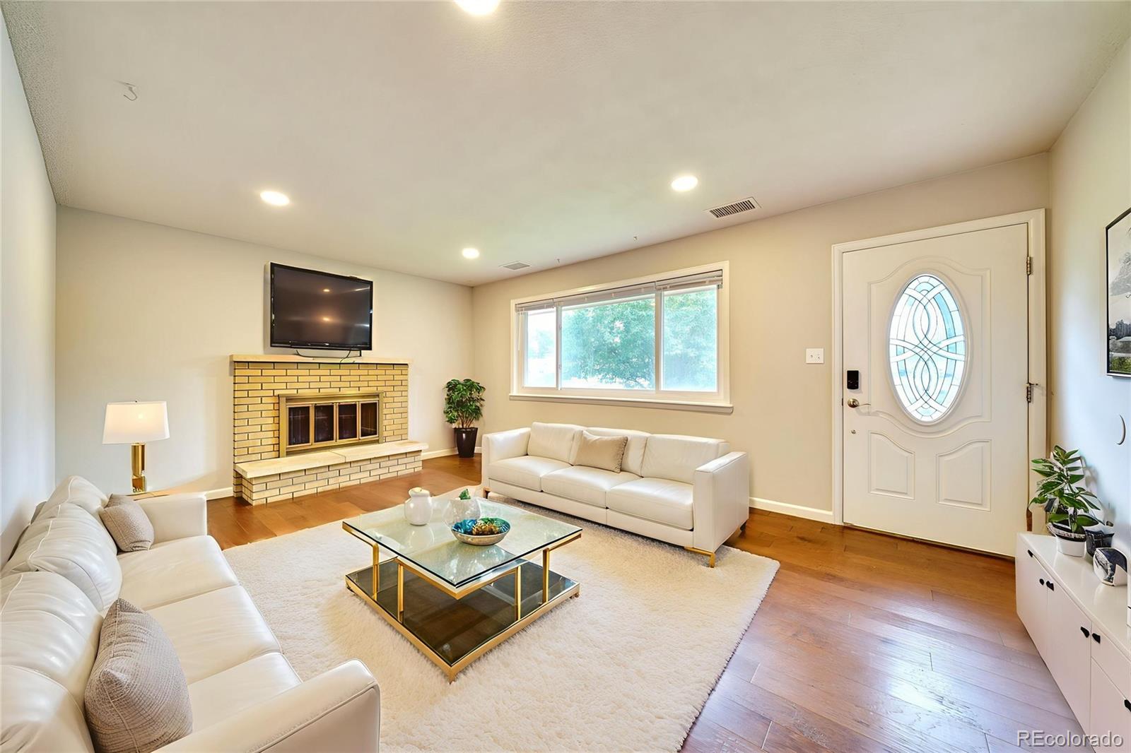 1206 Westmoreland Road Colorado Springs, CO 80907 - Photo 4 of 33 a living room with furniture fireplace and flat screen tv