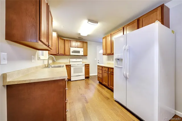 a kitchen with stainless steel appliances a refrigerator and a sink