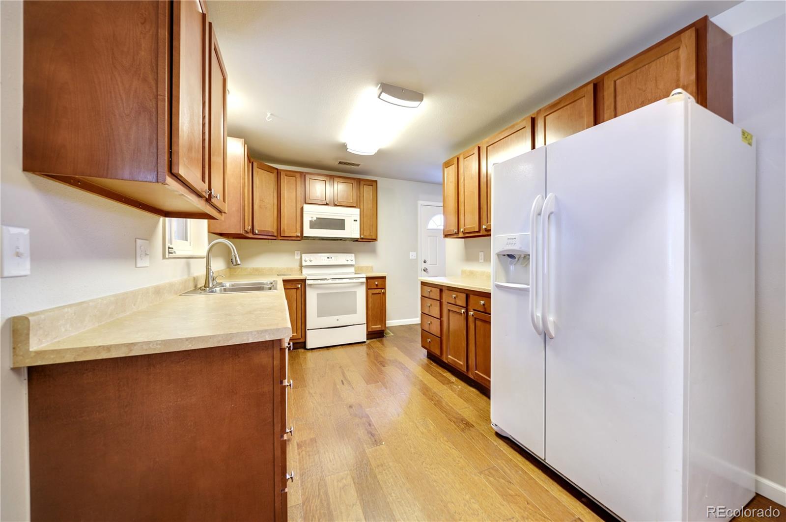 1206 Westmoreland Road Colorado Springs, CO 80907 - Photo 6 of 33 a kitchen with stainless steel appliances a refrigerator and a sink