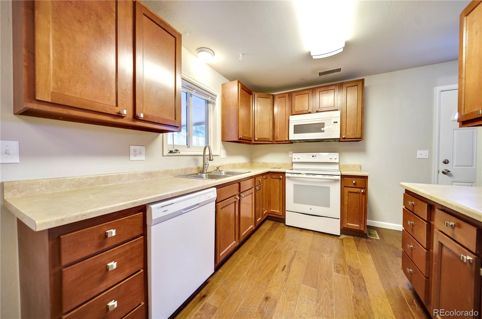 1206 Westmoreland Road Colorado Springs, CO 80907 - Photo 8 of 33 a kitchen with white cabinets appliances and a sink