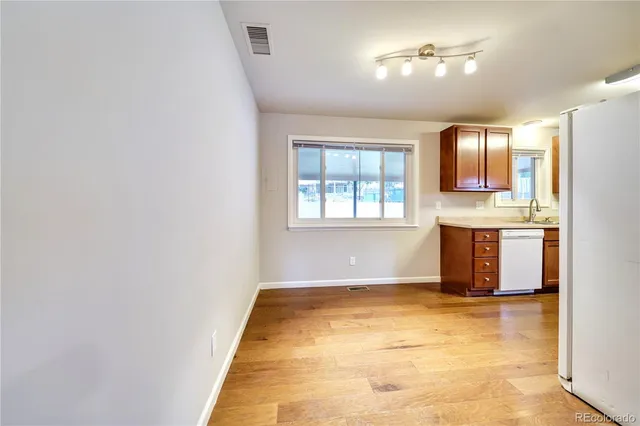 a view of kitchen with window and refrigerator